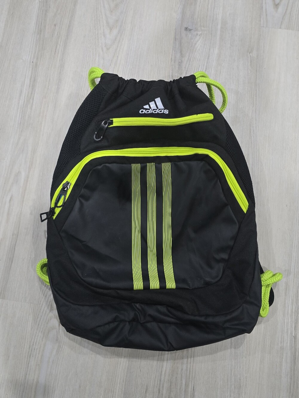 Adidas Alliance II Sackpack in a black and neon/solar green colorway.